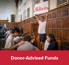 Students holding a sign. Links to Donor-Advised Funds