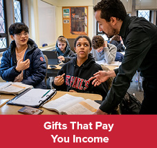 A teacher helping students. Gifts That Pay You Income